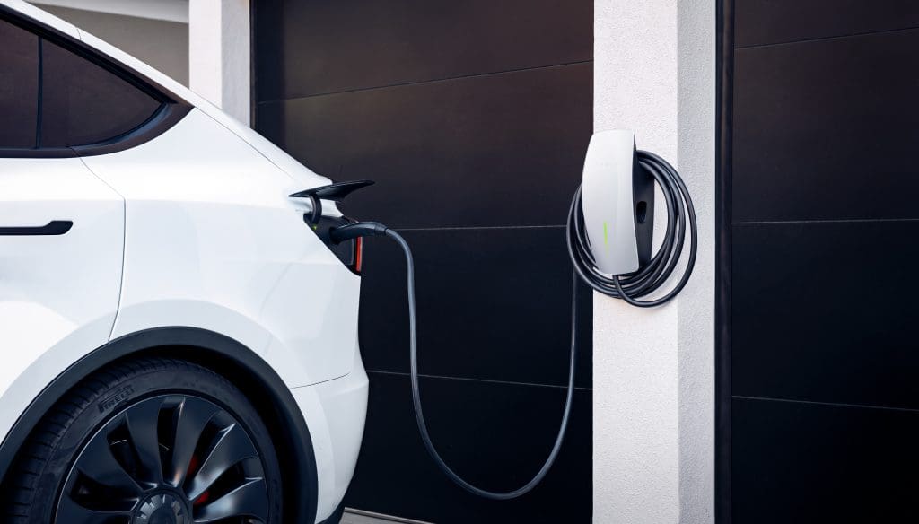 How the UK is using electric vehicles to strengthen and clean its power grid 1 A Tesla electric vehicle charging at home
