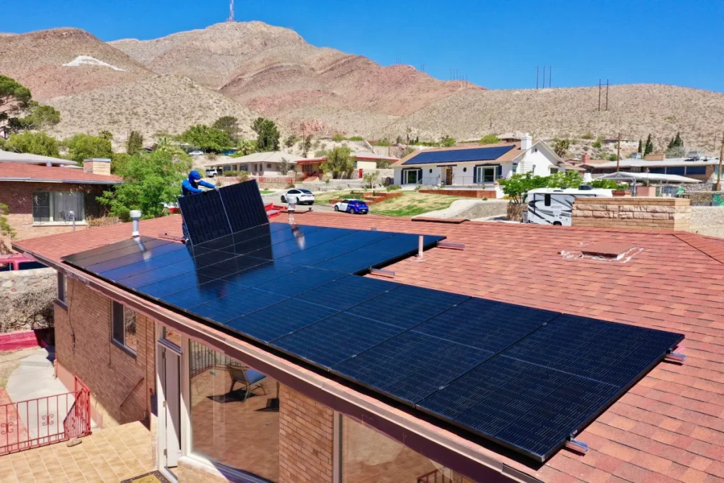 El Paso solar cooperative helps homeowners save thousands on rooftop solar 1 A man installing solar panels on a rooftop in El Paso